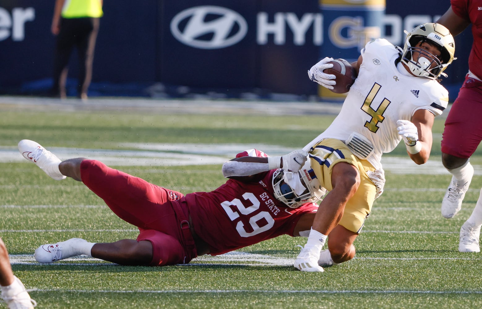 South Carolina State Bulldogs linebacker Jadin Jones (29) attempts a shirt tackle on Georgia Tech Yellow Jackets running back Dontae Smith (4) during a football game against South Carolina State at Bobby Dodd Stadium in Atlanta on Saturday, September 9, 2023.   (Bob Andres for the Atlanta Journal Constitution)