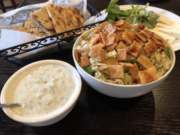 The mast-o-khiar (yogurt with cucumber), and fatoosh salad. Rear: Sangak bread and tray of herbs and cheese at Taaj Kabob & Grill. CONTRIBUTED BY WENDELL BROCK