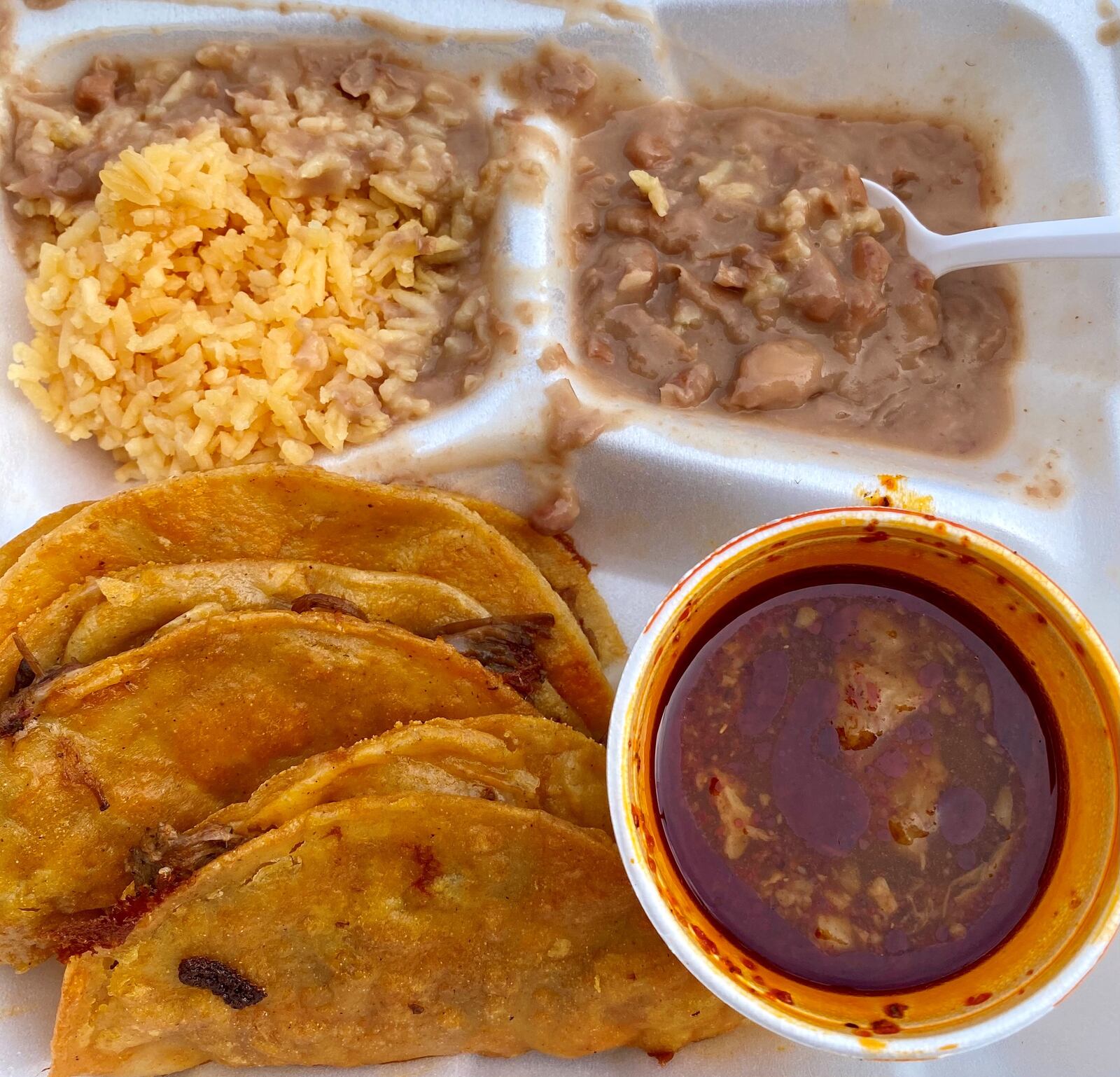 Mauro Cruz, aka Chef Smokey, makes delicious birria tacos. Seen here is the three-taco plate with beans and rice. Wendell Brock for The Atlanta Journal-Constitution