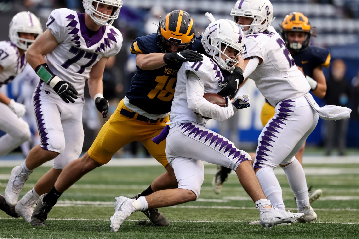 Trinity Christian wide receiver Javan Harrison (11) is tacked by Prince Avenue Christian linebacker Luke Lanier (18) on a kick off return by Harrison in the first half of the Class 1A Private championship at Center Parc Stadium Monday, December 28, 2020 in Atlanta, Ga.. JASON GETZ FOR THE ATLANTA JOURNAL-CONSTITUTION