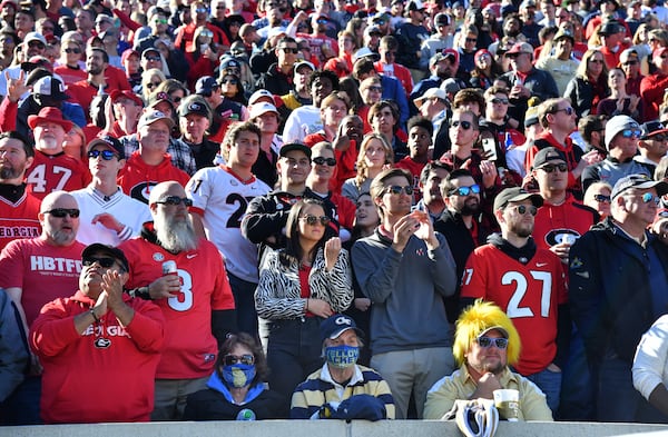 Georgia Tech fans are surrounded by Georgia fans during the second half of an NCAA college football game at Georgia Tech's Bobby Dodd Stadium in Atlanta on Saturday, November 27, 2021. Georgia won 45-0 over Georgia Tech. (Hyosub Shin / Hyosub.Shin@ajc.com)