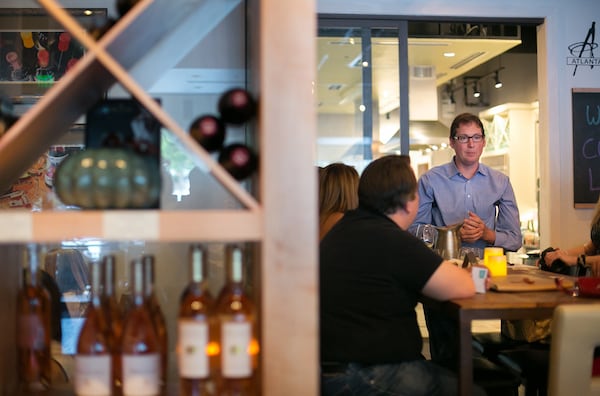 Michael Bryan speaks with customers at Vino Venue in Dunwoody.