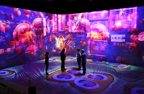 Visitors receive a glimpse of Illuminarium in Atlanta before its scheduled opening date in July. Curtis Compton / Curtis.Compton@ajc.com