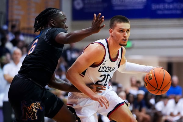 Memphis guard Baraka Okojie (6) guards against UConn guard Aidan Mahaney (20) during the first half of an NCAA college basketball game at the Maui Invitational Monday, Nov. 25, 2024, in Lahaina, Hawaii. (AP Photo/Lindsey Wasson)