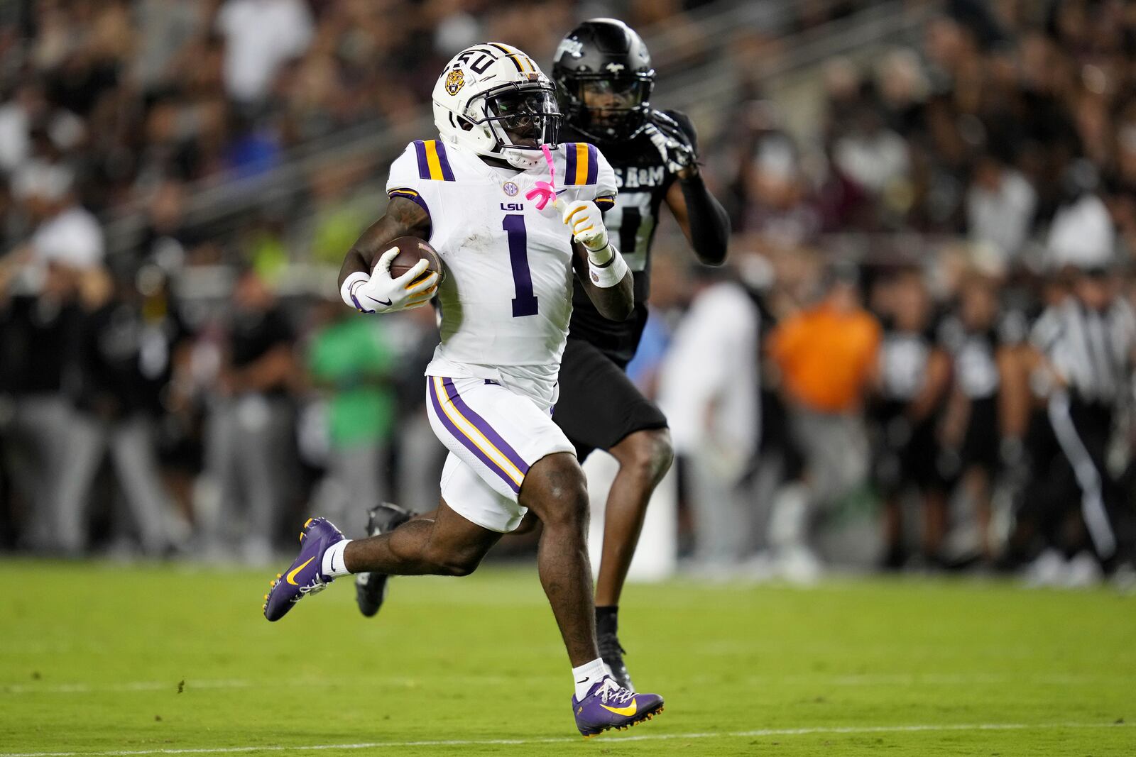 LSU wide receiver Aaron Anderson (1) races to the end zone for a 76 yard catch and run as LSU safety Dashawn Spears (10) tries to catch him during the first half of an NCAA college football game Saturday, Oct. 26, 2024, in College Station, Texas. (AP Photo/Sam Craft)