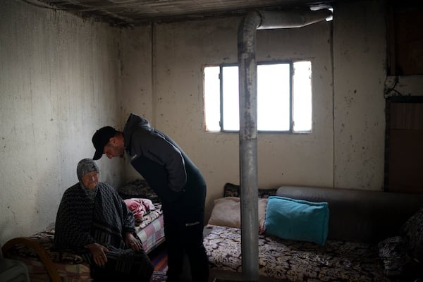 Salem Adra, brother of Palestinian activist Basel Adra, who won Best Documentary Feature at the Oscars for "No Other Land", talks to his grandmother Sarah, 87, at her house in the West Bank village of Tuwani, Monday, March 3, 2025. (AP Photo/Leo Correa)