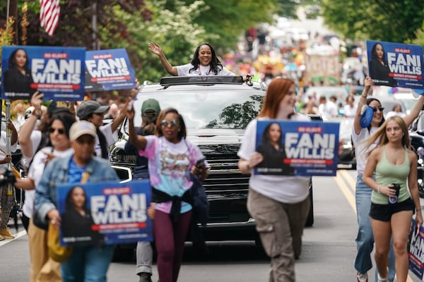 Fulton County District Attorney Fani Willis (in vehicle) and her supporters campaign during a recent parade in Atlanta.