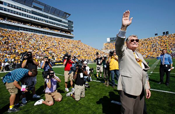 Former Iowa football coach Hayden Fry waves to the crowd on Sept. 5, 2009, as he is introduced before Iowa's game against Northern Iowa.