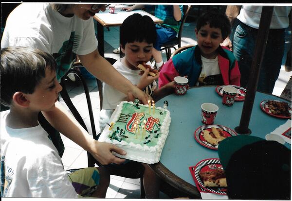 Writer Bill King’s son Bill is presented with a baseball-themed cake during a party at Challenges arcade celebrating his eighth birthday. (Courtesy of the King family)