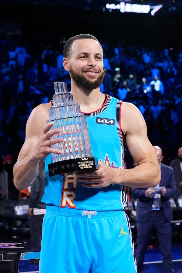 Golden State Warriors guard Stephen Curry holds the Most Valuable Player trophy after the NBA All-Star basketball game Sunday, Feb. 16, 2025, in San Francisco. (AP Photo/Godofredo A. Vásquez)