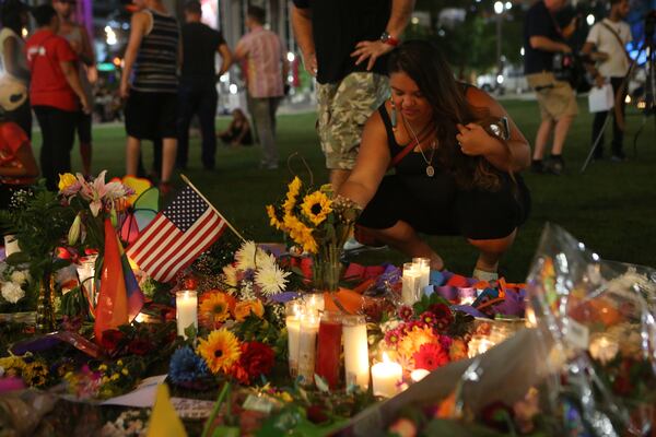 People gathered at a candlelight vigil in Orlando in the days following the Pulse nightclub shooting. AJC file photo: Curtis Compton