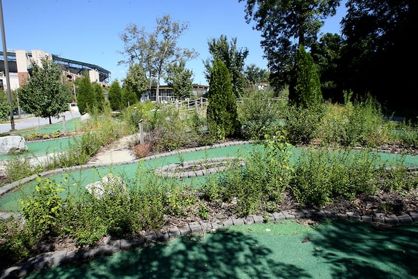 Weeds took over the FanPlex mini golf course in 2006 as the city struggled to find a buyer for the site. (Keith Hadley / AJC file)