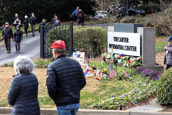 Mourners enter and leave the Carter Center in Atlanta on Sunday, January 5, 2025 to pay respects to former President Jimmy Carter, whose body is lying in repose at the center. (Arvin Temkar / AJC)