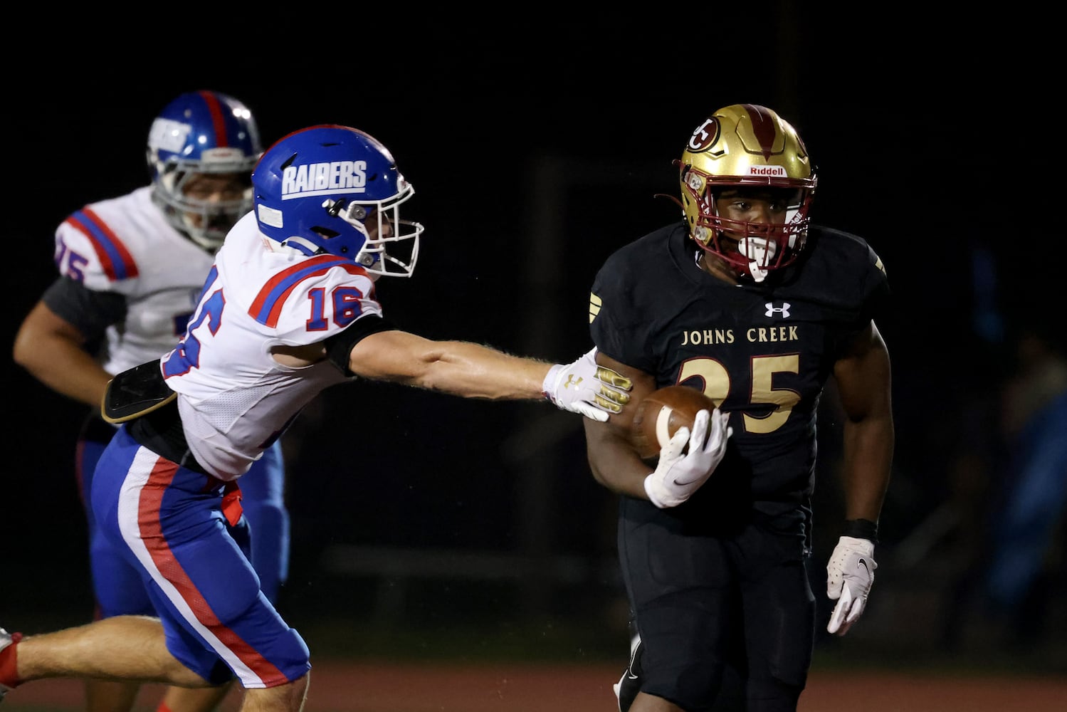 Sept. 24, 2021 - Johns Creek, Ga: Johns Creek running back Tylan Johnson (25) runs past Riverwood defensive back Zach Cigelske (16) for a long run during the second half at Johns Creek high school Friday, September 24, 2021 in Johns Creek, Ga.. Johns Creek won 40-32. JASON GETZ FOR THE ATLANTA JOURNAL-CONSTITUTION