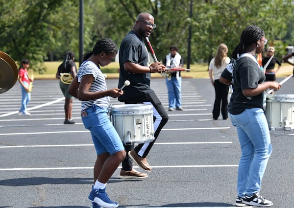 Twiggs County High School band director Ernest Stackhouse leads the band in practice at Twiggs County High School, Thursday, August 29, 2024, in Jeffersonville. This is a feature profile on Twiggs County High School band director Ernest Stackhouse, a longtime, revered band leader in one of Georgia's tiniest counties. He is a beloved character who came from humble beginnings who has devoted his career to helping students who, like him, often hail from similar backgrounds. (Hyosub Shin / AJC)