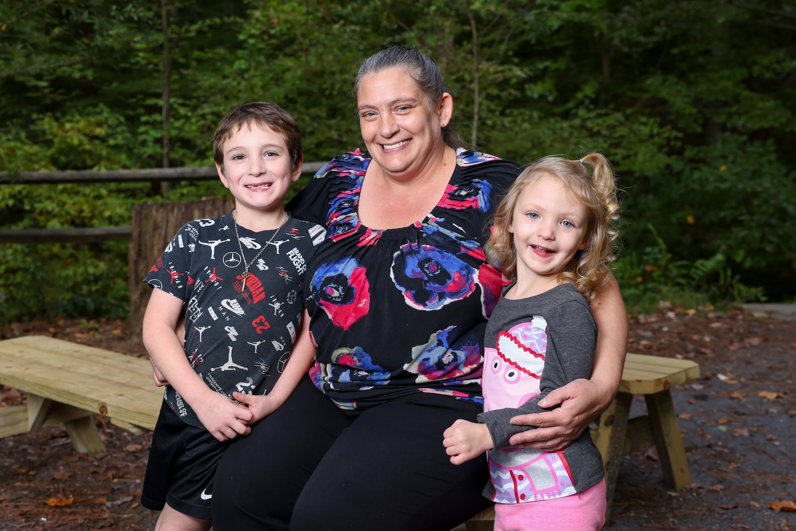 Melissa Fountain (center) and her two children, Elijah (left) and Angelina, at a park Tuesday, October 15, 2024, in Dunwoody. Jason Getz/AJC

