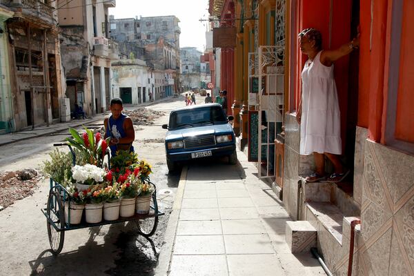 A flower salesman pushes his cart down a street in Havana. While the Internet is essential for today's business, Cuba still has some of the worst Internet access in the world.