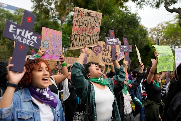 People take part in a march marking the upcoming International Day for the Elimination of Violence Against Women, in Lima, Peru, Saturday, Nov. 23, 2024. (AP Photo/Guadalupe Pardo)