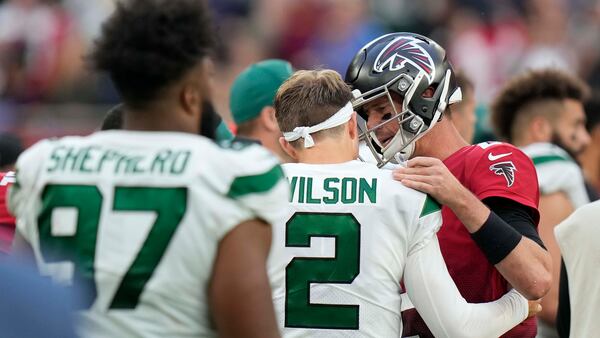 Falcons quarterback Matt Ryan (2) talks to New York Jets quarterback Zach Wilson (2) after Falcons' 27-20 win over Jets Sunday, Oct. 10, 2021, at the Tottenham Hotspur stadium in London, England. (Alastair Grant/AP)