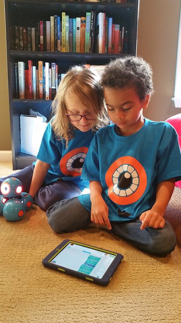 First-graders Camille Mascarenas and Drew Williams, co-captains of Robot Ninja Helpers, perform coding with their Dash robot. The Cobb County first-graders placed second in their age group recently in the international Wonder League Robotics Competition of some 5,000 teams. CONTRIBUTED