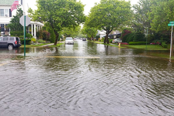 Cars are parked on a flooded street in Ventnor, N.J., Friday, July 10, 2020. Fast-moving Tropical Storm Fay made landfall in New Jersey on Friday amid heavy, lashing rains that closed beaches and flooded shore town streets. (Kristian Gonyea/The Press of Atlantic City via AP)