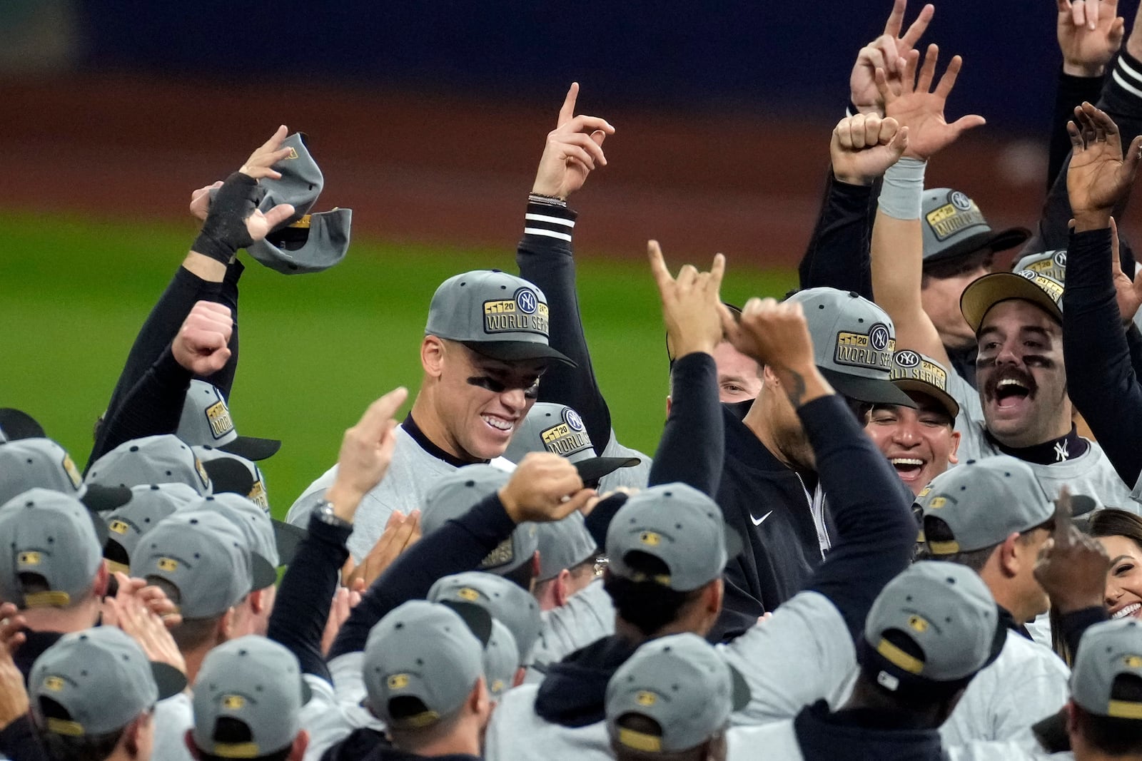 New York Yankees players celebrate after Game 5 of the baseball AL Championship Series against the Cleveland Guardians Sunday, Oct. 20, 2024, in Cleveland. The Yankees won 5-2 to advance to the World Series. (AP Photo/Jeff Roberson)