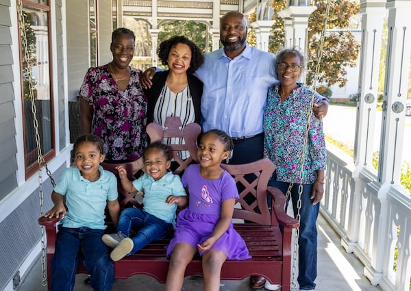 (counter clockwise from front left)  Frederick "Tre" Durden (age 3) sits with his brother Isaiah (1) and sister Zoe (5)  on the swing while his grandmother Mary, father Frederick, mother Tonia and aunt Linda Jackson pose for a family photo on the porch of their Newnan home. PHIL SKINNER FOR THE ATLANTA JOURNAL-CONSTITUTION.