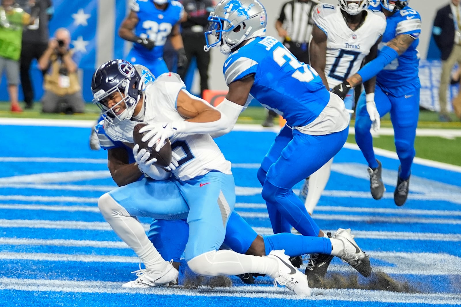 Tennessee Titans wide receiver Nick Westbrook-Ikhine, left, catches a pass in the end zone for a touchdown against the Detroit Lions safety Kerby Joseph, right, during the first half of an NFL football game Sunday, Oct. 27, 2024, in Detroit. (AP Photo/Paul Sancya)