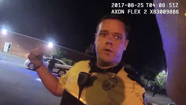 In a still image from body camera footage released Monday by Asheville, N.C., police officials, Officer Christopher Hickman talks to a supervisor, Sgt. Lisa Taube, the morning of Aug. 25, 2017, about a confrontation with Johnnie Rush. Rush, 33, was walking home from work that morning when Hickman and his partner accused the Cracker Barrel employee of jaywalking. The subsequent confrontation, caught on camera and shared by a local newspaper in February, led to community outrage and a felony charge of assault by strangulation against Hickman, who resigned in January.