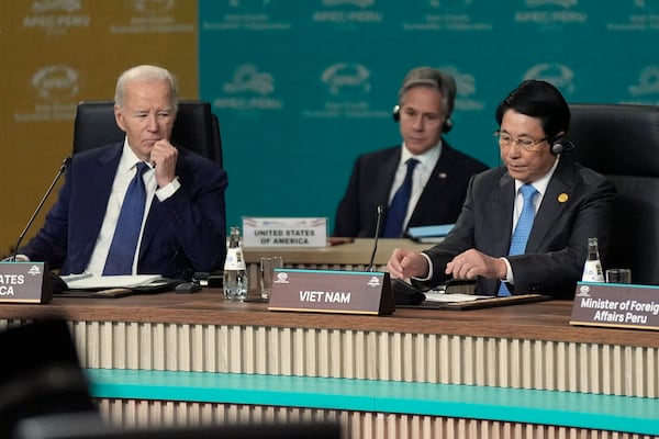 President Joe Biden, left, and President of Vietnam Luong Cuong, right, with Secretary of State Antony Blinken looking on in background, participate in the APEC Leaders' Informal Dialogue at the APEC Summit in Lima, Peru, Friday, Nov. 15, 2024. In background at left is Secretary of State Antony Blinken. (AP Photo/Manuel Balce Ceneta)