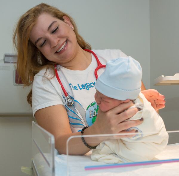 Hanan Waite, of Earth’s Angels, burps a newborn baby at the Northside Hospital Women’s Center in Atlanta. (Photo by Phil Skinner)