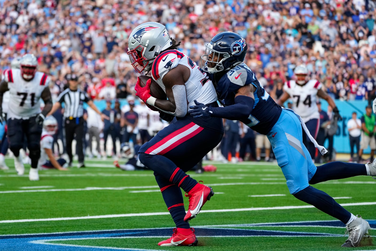 New England Patriots running back Rhamondre Stevenson (38) makes a catch in front of Tennessee Titans cornerback Darrell Baker Jr. (39) for a touchdown at the end of the fourth quarter of an NFL football game in Nashville, Tenn., Sunday, Nov. 3, 2024. (AP Photo/George Walker IV)