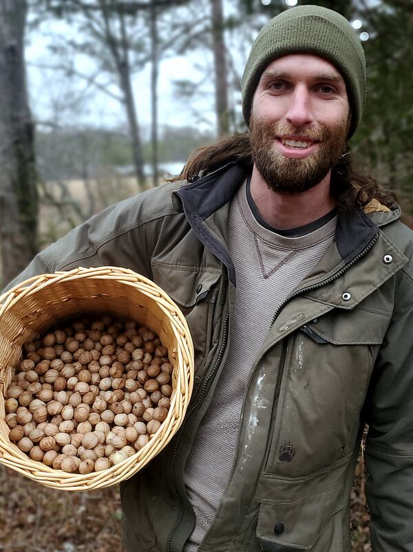 Caleb Arnold of Ever Wilder Farm proudly shows off a basket of hickory nuts that he foraged from the woods. 
(Courtesy of Caleb Arnold)