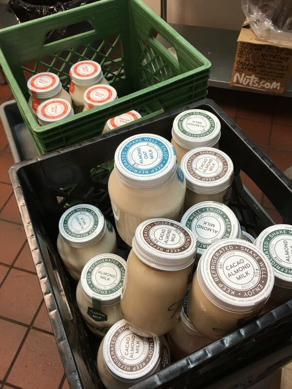 Treehouse Milk is available in many flavors. In the foreground are Almond Milk, Almond Oat Milk and Cacao Almond Milk. The red-capped bottles are Pecan Milk. (Photo credit: Lucie Canfield)