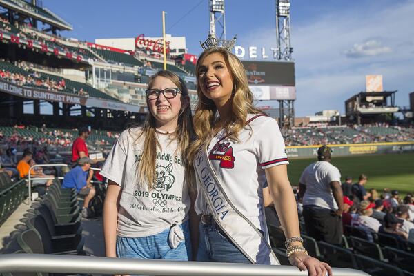 Miss Georgia 2018 Annie Jorgensen (right) takes a photo with Presley Robertson of Acworth before the start of a recent Braves game at SunTrust Park. ALYSSA POINTER / ALYSSA.POINTER@AJC.COM