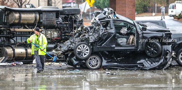 Authorities said a tractor-trailer ran into a car in front of it, sending both vehicles  into the parking lot of a Gwinnett County QuikTrip.