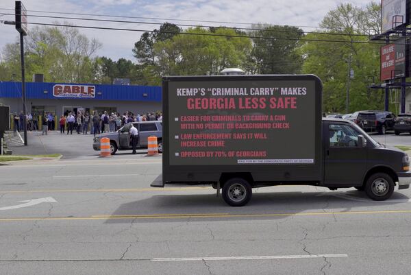 As Gov. Brian Kemp prepared to sign a gun expansion into law, state Democrats arranged for this mobile billboard to patrol the streets outside. 