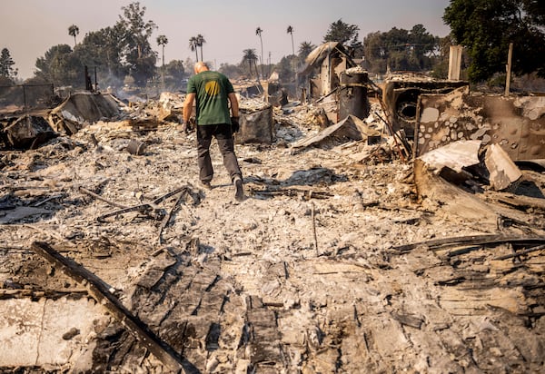 Marvin Meador walks on the remains of his fire-ravaged property after the Mountain Fire swept through, Thursday, Nov. 7, 2024, in Camarillo, Calif. (AP Photo/Ethan Swope)