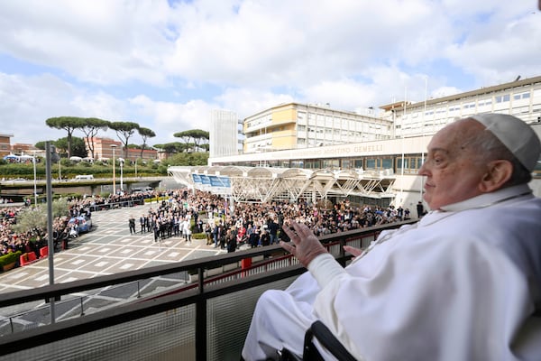 Pope Francis waves as he appears at a window of the Agostino Gemelli Polyclinic in Rome, Sunday, March 23, 2025, where he has been treated for bronchitis and bilateral pneumonia since Feb. 14. (Francesco Sforza/Vatican press office via AP)