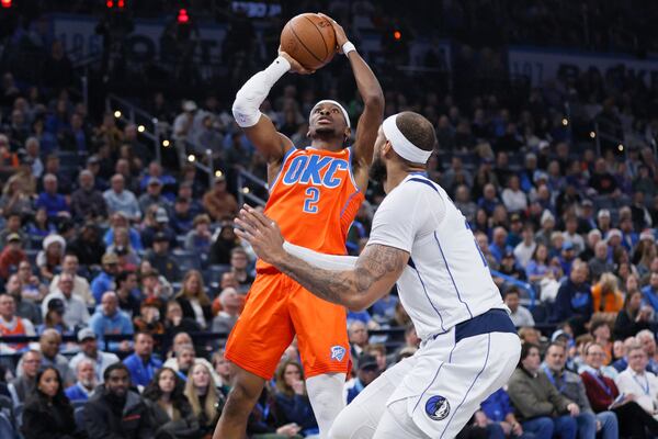 Oklahoma City Thunder guard Shai Gilgeous-Alexander (2) shoots against Dallas Mavericks center Daniel Gafford, right, during the first half of an Emirates NBA Cup basketball game, Tuesday, Dec. 3, 2024, in Oklahoma City. (AP Photo/Nate Billings)