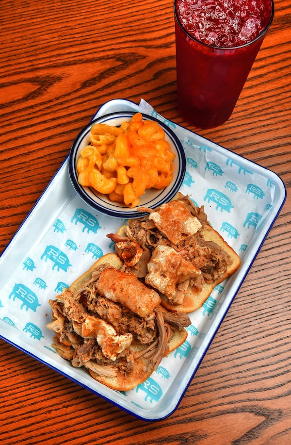 Rod's Original Whole Hog Pork Sandwich "The King of the Menu," shown with mac and cheese, at Rodney Scott's Whole Hog BBQ in Atlanta. (Chris Hunt for The Atlanta Journal-Constitution)