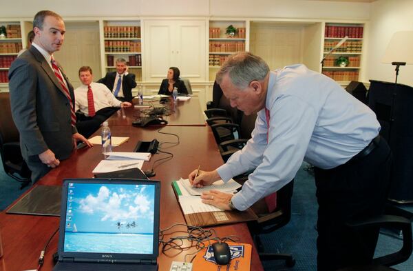 Nathan Deal makes some notes on the original copy of his inauguration speech after speech rehearsal in the governor’s conference room in January 2011. From left are Brian Robinson, director of communications, Chris Riley, Chief of staff, Michael Shaffer, Deputy Chief of Staff for Legislative and External Affairs and Erin Hames, Deputy Chief of Staff for Policy. Deal appointed Hames to the state Board of Regents. Bob Andres bandres@ajc.com