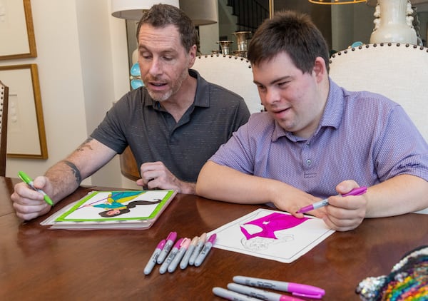 David Hughens (left) & Jay Thomas Carr color together at Carr's home in Suwanee. PHIL SKINNER FOR THE ATLANTA JOURNAL-CONSTITUTION