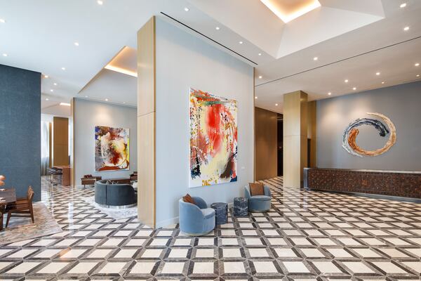 Lobby of The Joseph, a Luxury Collection Hotel, Nashville, featuring paintings by Jackie Saccoccio, ceramic art by Brie Ruais, and a custom designed, hand-tooled leather front desk by Lucchese.