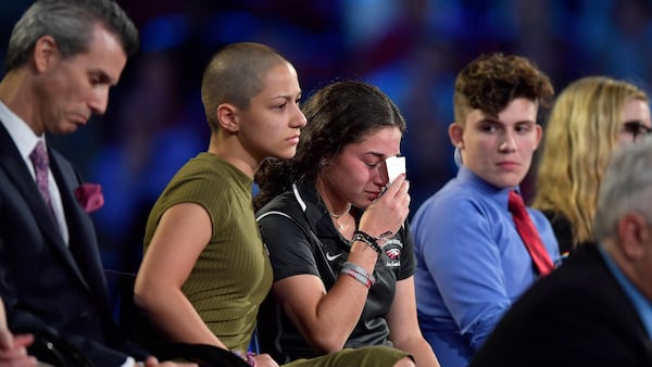 Marjory Stoneman Douglas High School student Emma Gonzalez comforts a classmate during a CNN town hall meeting, Wednesday, Feb. 21, 2018, at the BB&T Center, in Sunrise, Fla. (Michael Laughlin/South Florida Sun-Sentinel via AP)