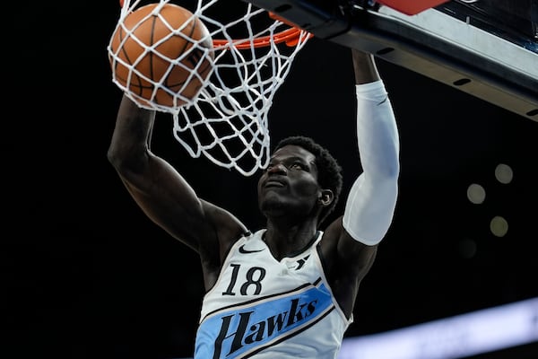 Atlanta Hawks forward Mouhamed Gueye (18) dunks against the Golden State Warriors during the first half of an NBA basketball game, Saturday, March 22, 2025, in Atlanta. (AP Photo/Mike Stewart)