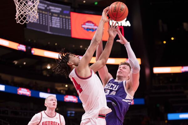 Georgia forward Asa Newell (14) and Grand Canyon forward Duke Brennan (24) battle for a rebound during the first half of an NCAA college basketball game, Saturday, Dec. 14, 2024, in Atlanta. (AP Photo/Kathryn Skeean)