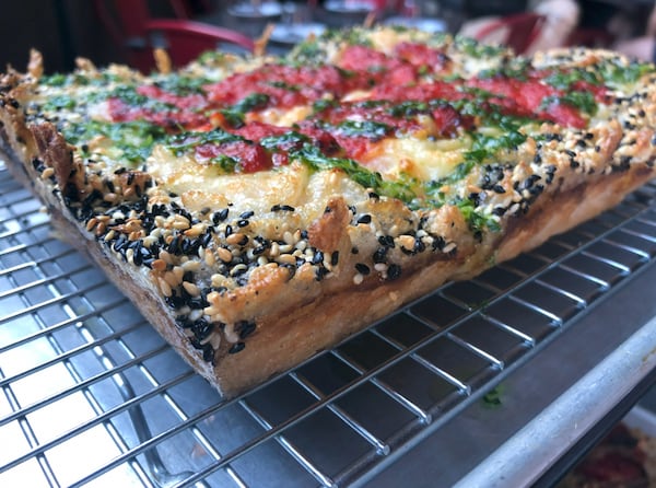 Emmy Squared's MVP pizza can be made gluten-free and vegan, with a sesame seed-covered crust. (Danielle Meinert for The Atlanta Journal-Constitution)