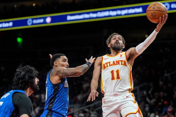 Atlanta Hawks guard Trae Young (11) shoots against the Orlando Magic during the first half of an NBA basketball game, Thursday, Feb. 20, 2025, in Atlanta. (AP Photo/Mike Stewart)