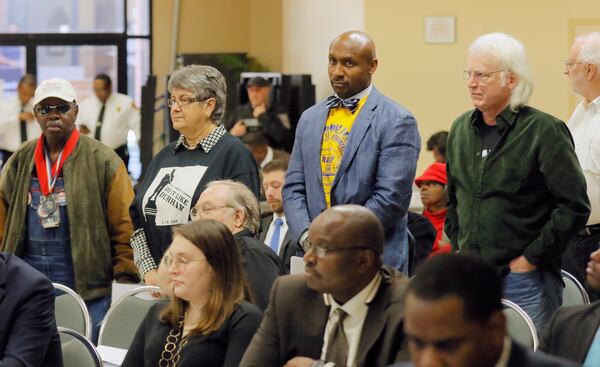  Supporters of removing a Confederate monument from Decatur stand in support of a speaker during public comment at the DeKalb County Commission.   The commission is expected to vote to explore removing the monument.  The vote wouldn't remove the monument immediately; rather, it would start an investigation into potential loopholes in state law allowing the county to take action.   BOB ANDRES  /BANDRES@AJC.COM